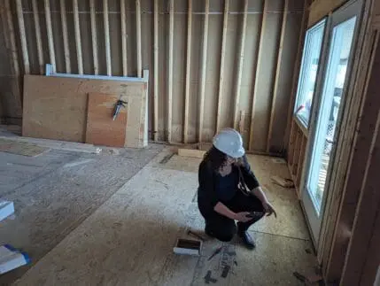An architectural designer draftsperson on the Gienapp Architects team using a Matterport scanner inside a building being renovated.